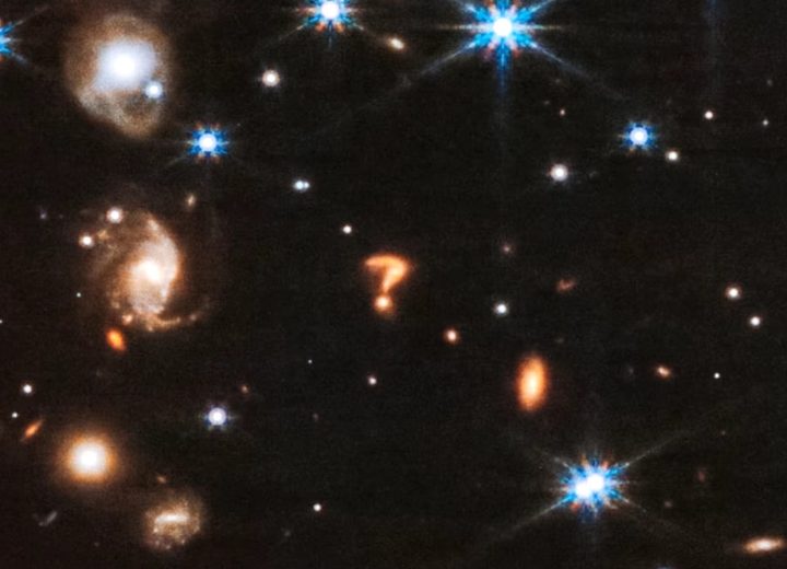 The shape of a question mark captured by the James Webb Space Telescope.