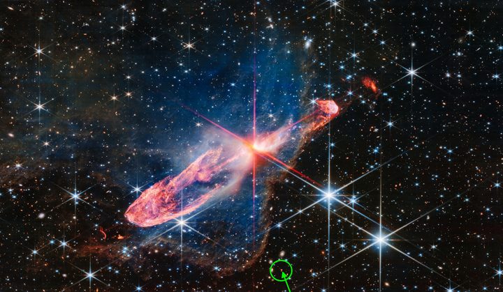 An image of deep space by the Webb telescope that also includes an object that's the shape of a question mark.