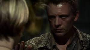 Cylon Leoben Conoy touches hands with Kara Thrace through a pane of glass in the Battlestar Galactica episode "Flesh and Bone."