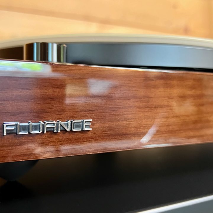 The front of the walnut plinth of the Fluance RT81+ turntable.