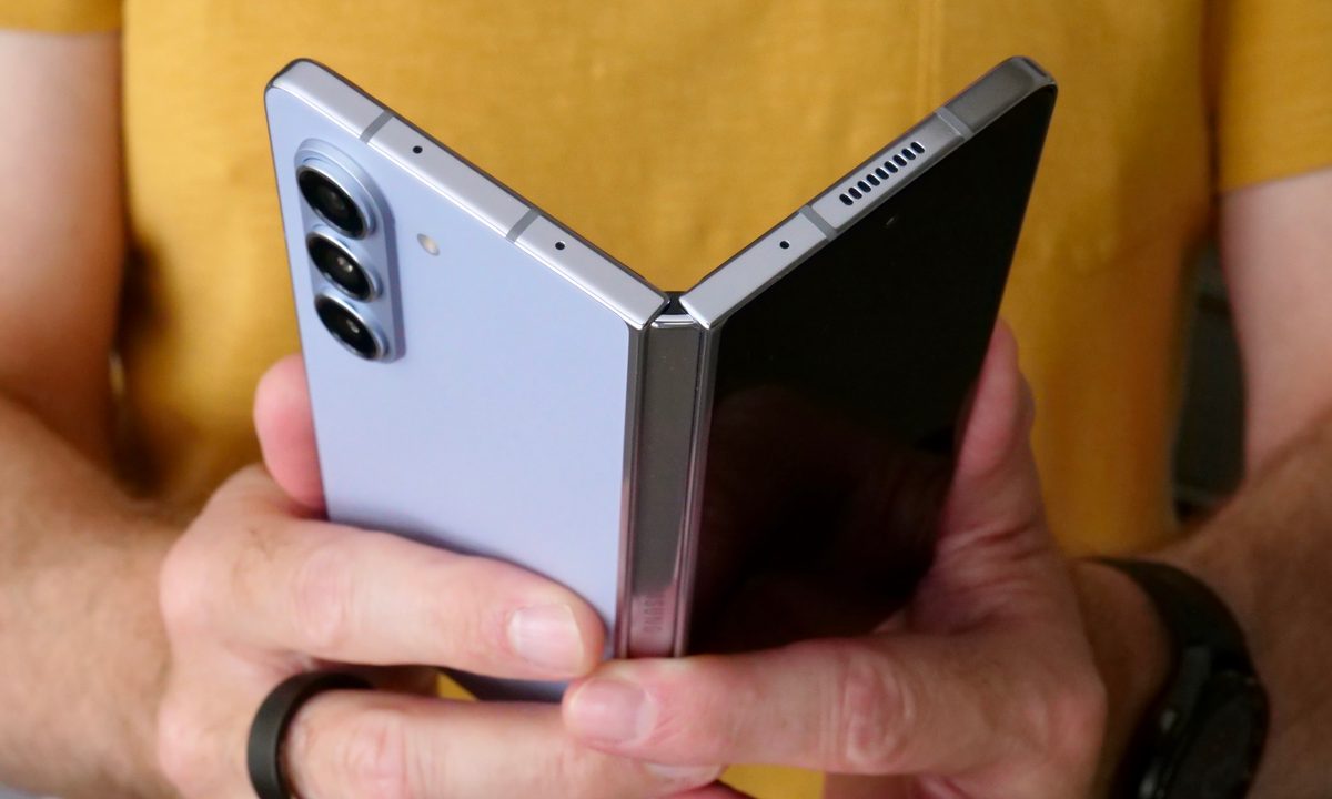 A person opening the Samsung Galaxy Z Fold 5.