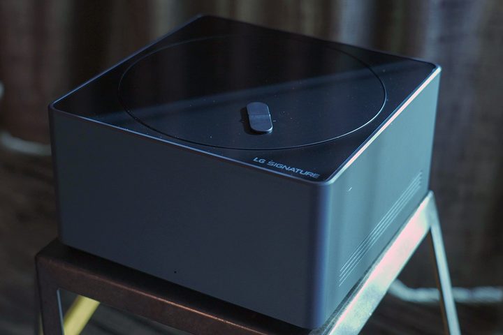 LG Signature M-Series OLED TV box on a stool.