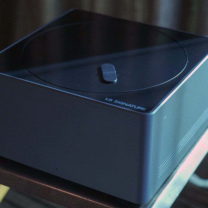 LG Signature M-Series OLED TV box on a stool.