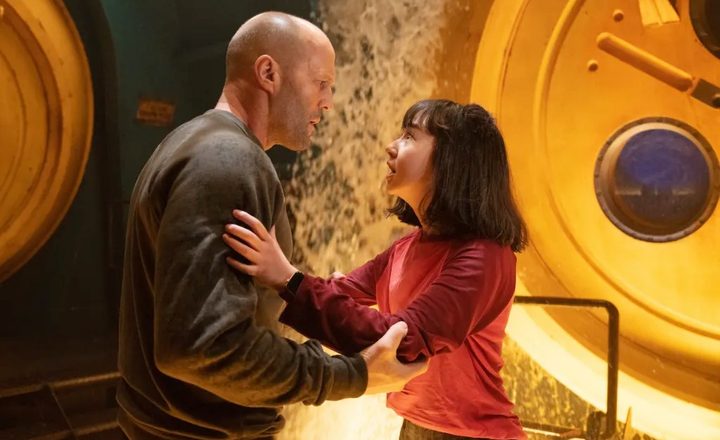 A man grips a little girl in The Meg 2.
