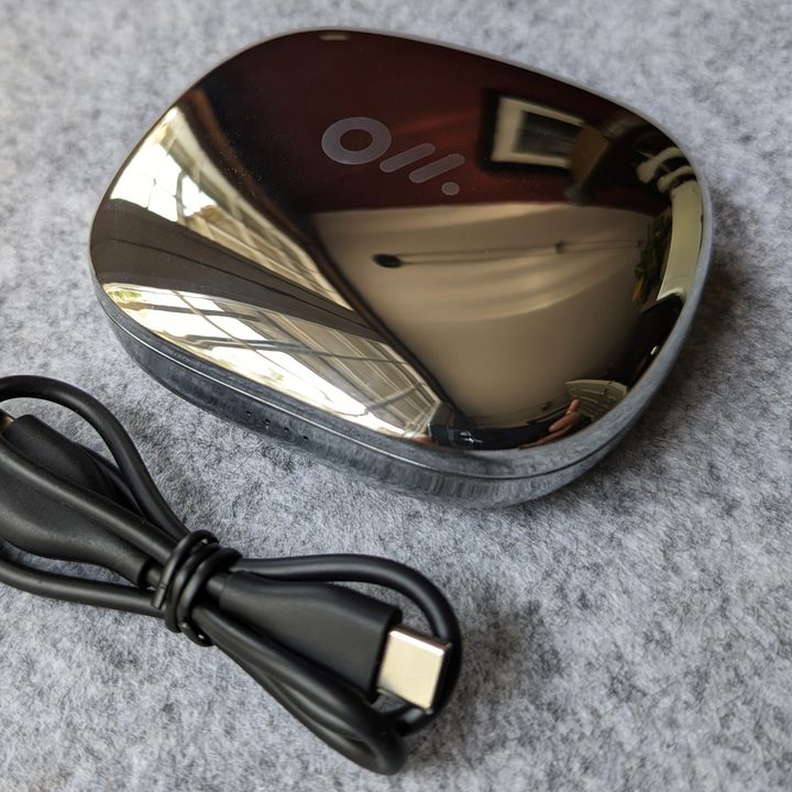 Oladance OWS Pro with charging cable.