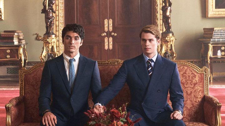 Two men hold each other's hands in Red, White & Royal Blue.