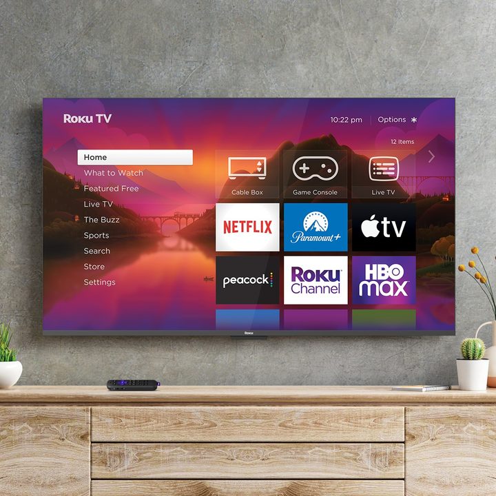 A Roku powered TV hanging on a wall running Roku OS 12.