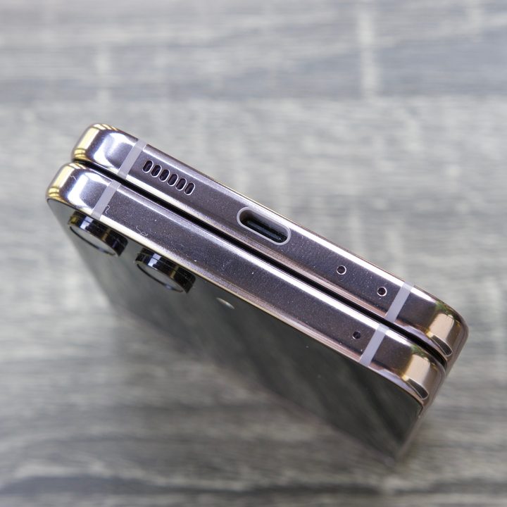 Samsung Galaxy Z Flip 5 closed shut, showing its USB-C port and speaker grille.