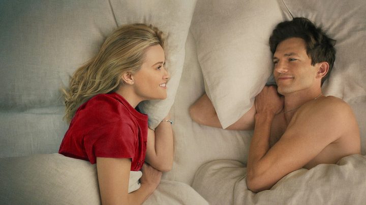 Two people lay in bed in Your Place or Mine.