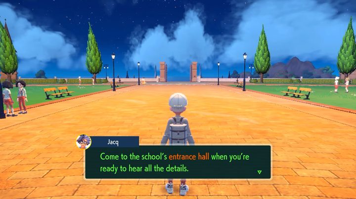A trainer talking to Jacq on a stone path.