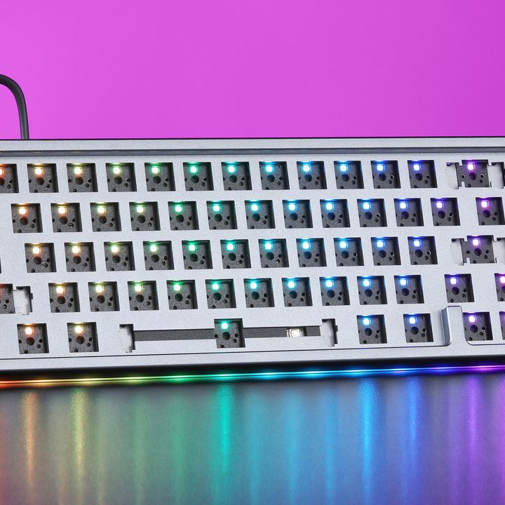 A barebones mechanical keyboard from Drop over a fuchsia background.