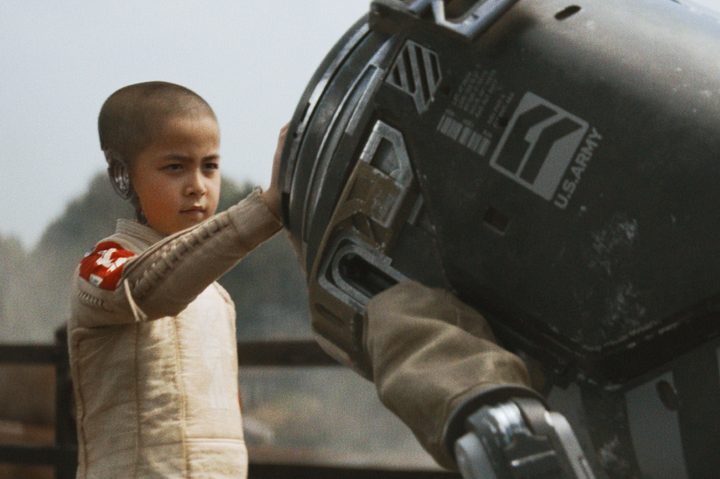 Alphie touches a robotic bomb in The Creator.
