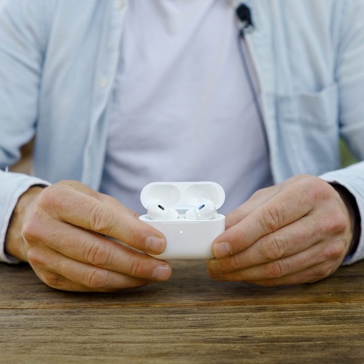 A man holds the open case of the Apple AirPods Pro 2 with USB-C and MagSafe case.