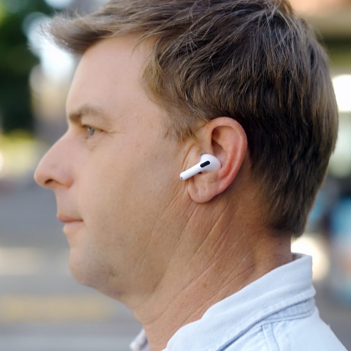 Profile of a man wearing the Apple AirPods Pro 2 with USB-C and MagSafe case.