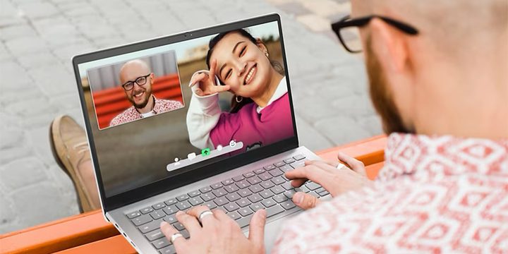 Someone using the Dell Inspiron 14 on their laptop to take a video call.