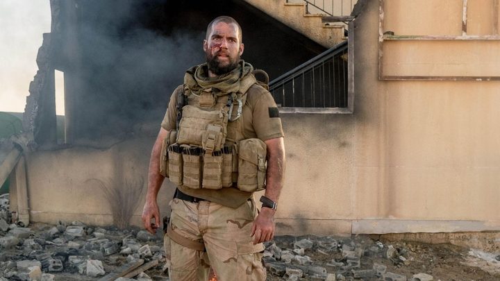 Henry Cavill as Captain Syverson looking ahead with a determined expression in Sand Castle.