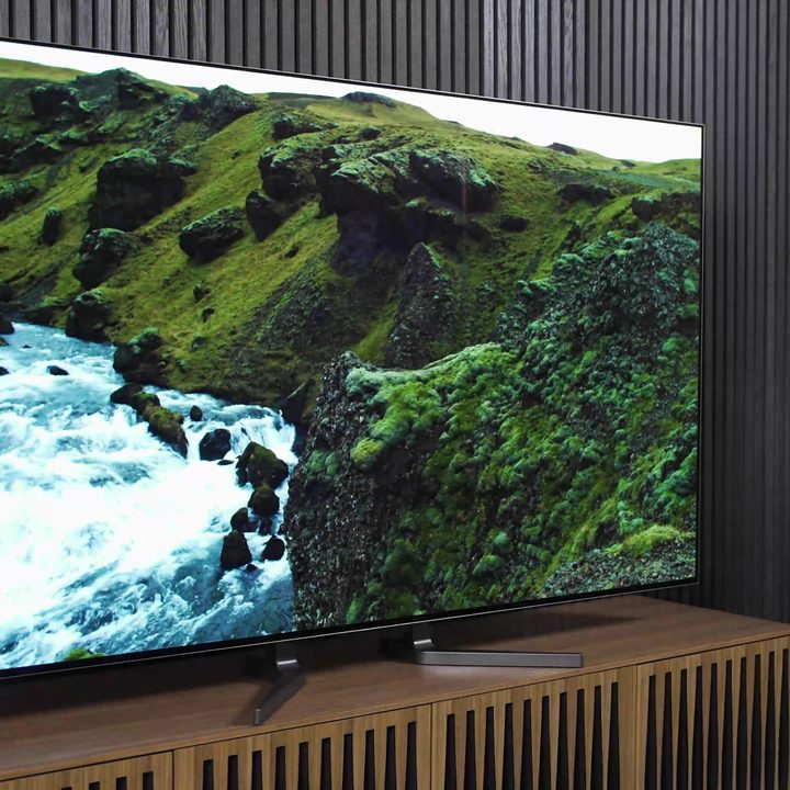A coastal landscape on an LG M3 Wireless OLED.
