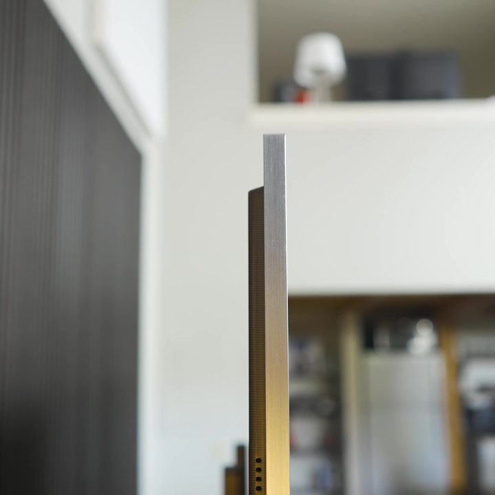 A profile view of the thing LG M3 Wireless OLED.