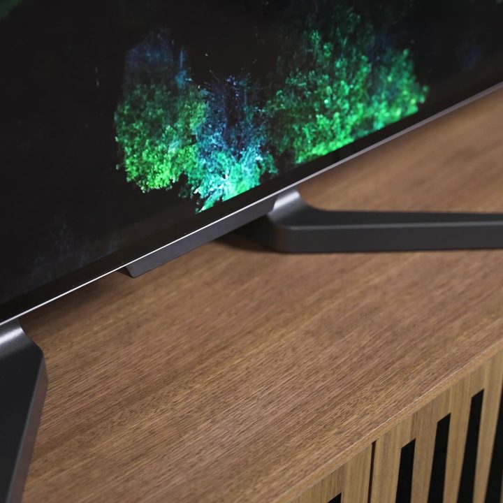 The feet of LG M3 Wireless OLED on a media console.