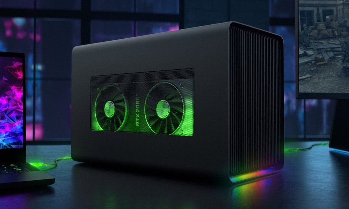 The Razer Core X Chroma external graphics card on a desk next a laptop and a monitor.