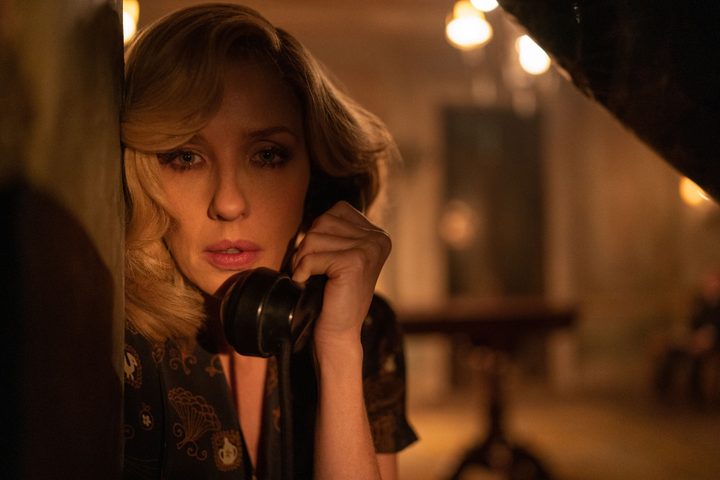 Rowena Drake holds a telephone in A Haunting in Venice.