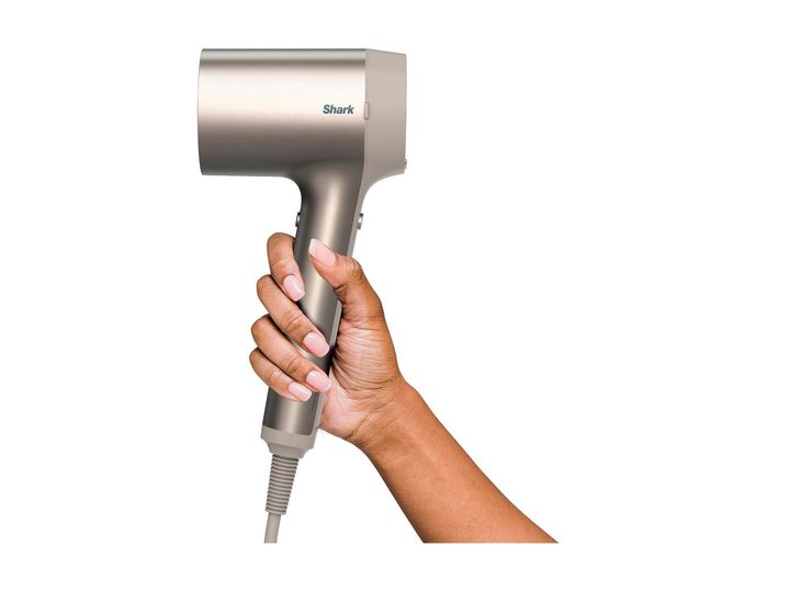 A woman holding the Shark HyperAir Hair Blow Dryer.