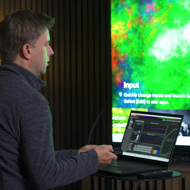A man measures color balance on a Sony X95L mini-LED.