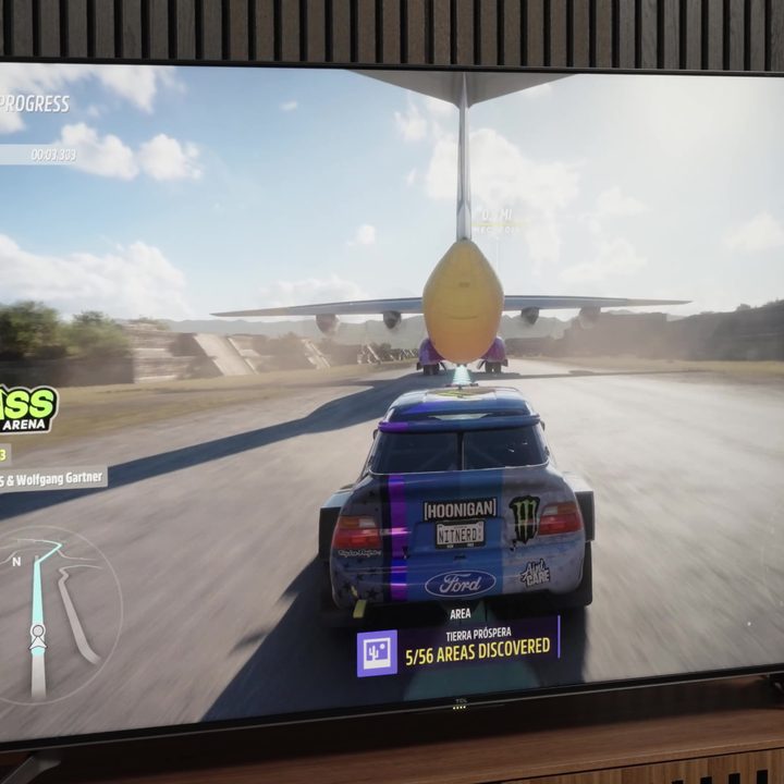 A car-racing video game on a TCL Q7 TV.