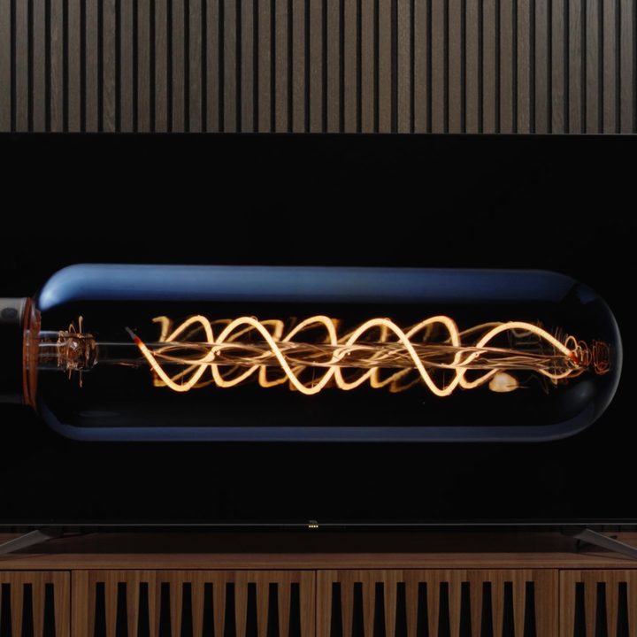 The filaments of an Edison style lightbulb displayed on a TCL Q7 TV.