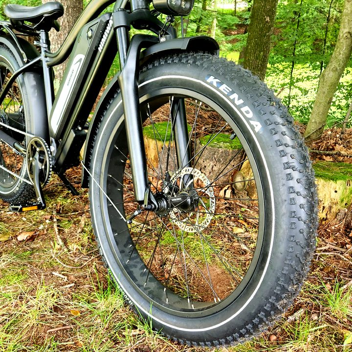 The Himiway Cruiser's moderately knobby fat tires allow riding on and off road.