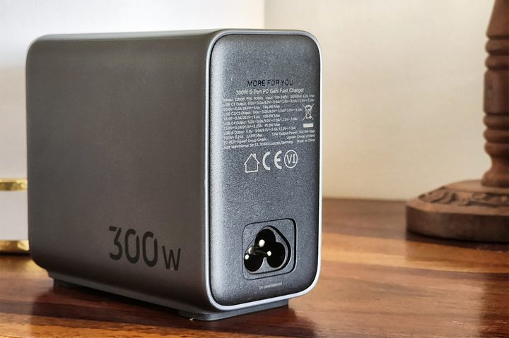 Ugreen 300W GaN fast charger with four USB-C and one USB-A port on table top.