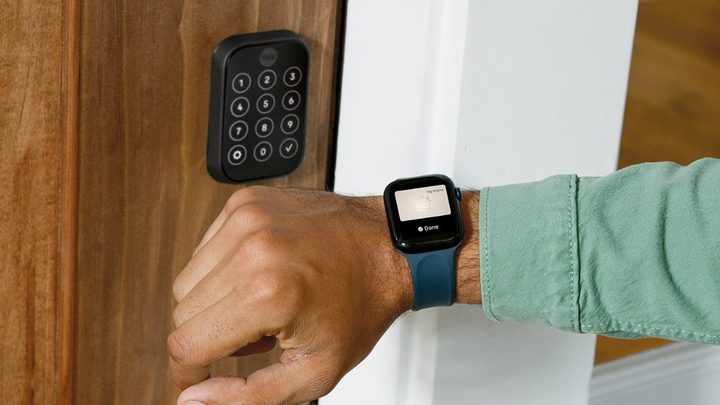 A person opening the Yale Assure Lock 2 with their Apple Watch.
