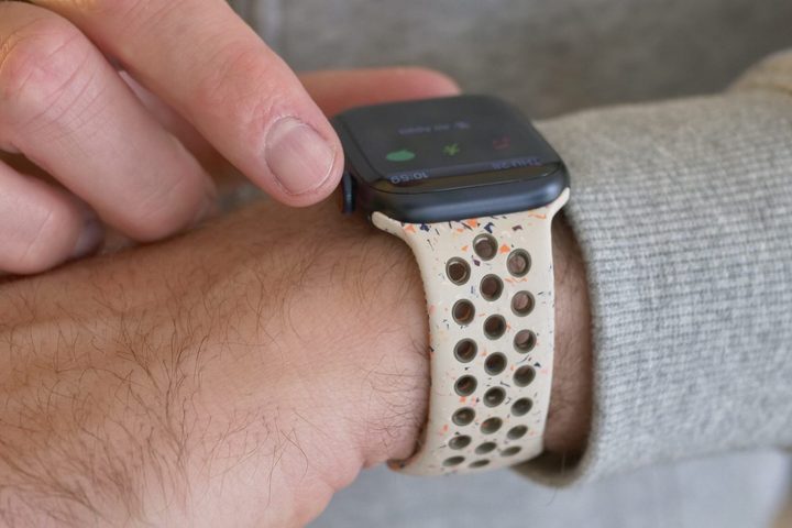A person wearing the Apple Watch Series 9, using the Digital Crown.