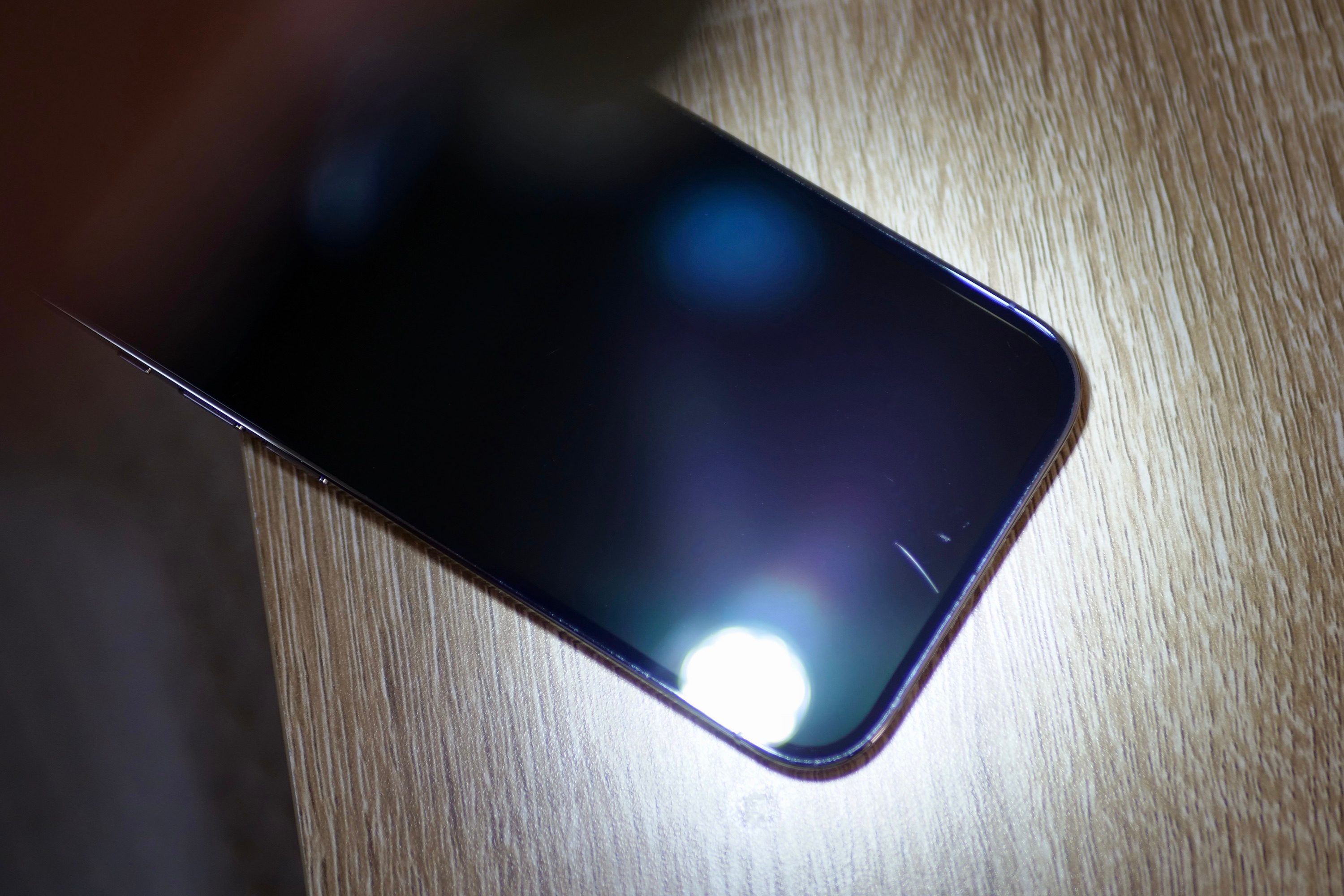 Ceramic Shield on the iPhone 14 Pro, with light to show scratches.