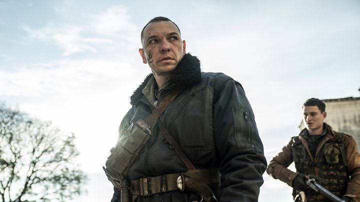 A man in a uniform looks on menacingly in a scene from The Walking Dead: Daryl Dixon.