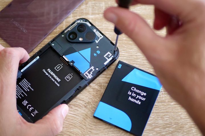 A person taking the Fairphone 5 apart.