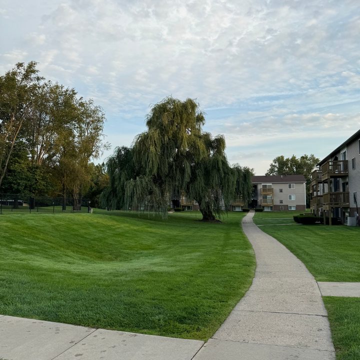 Photo of a sidewalk and courtyard in an apartment complex, taken with the iPhone 15 Pro Max's 1x camera.