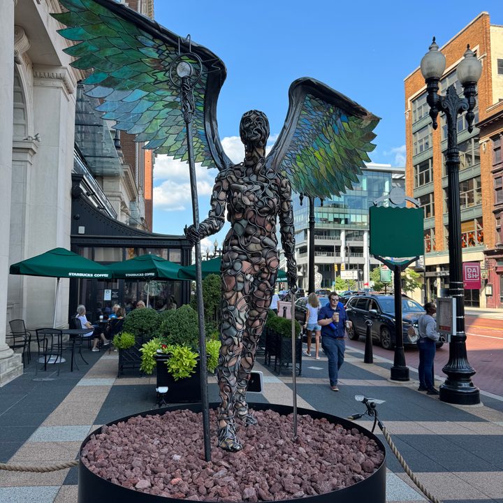 Photo from the iPhone 15 Pro Max main camera of a human statue with wings.