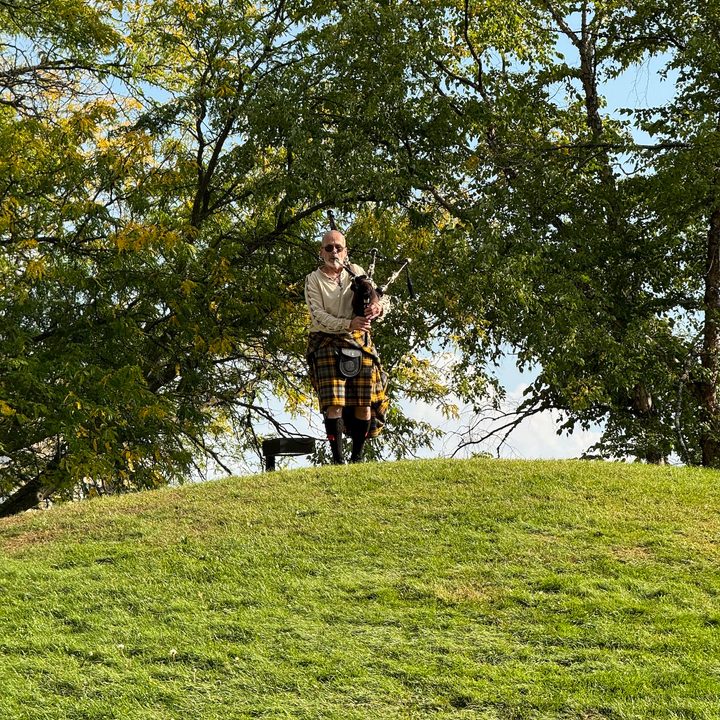Photo from the iPhone 15 Pro Max telephoto camera of a man playing bagpipes.