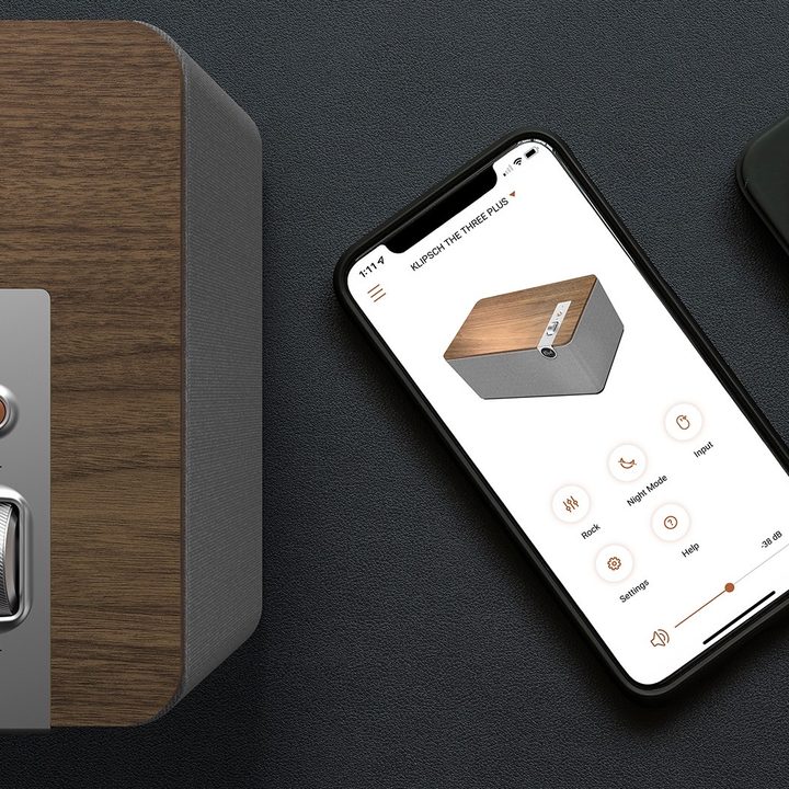 Klipsch The Three Plus tabletop wireless speaker seen with phone running the Klipsch Connect app.