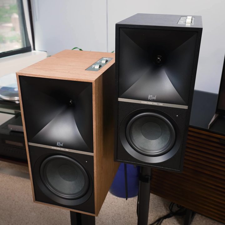 The left channel of both Klipsch The Nines and the Sevens on stands.