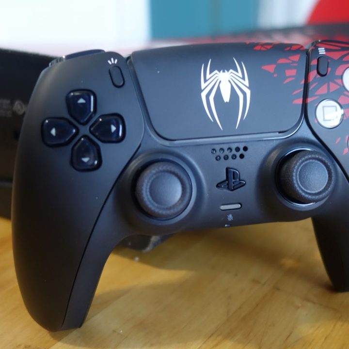 The special edition Spider-Man 2 DualSense stands on a table.