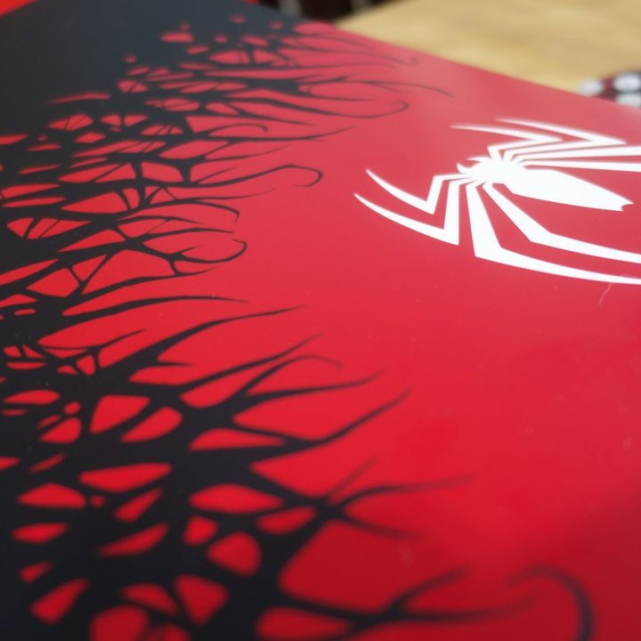 A close-up of the front of the Spider-Man 2 themed PS5.