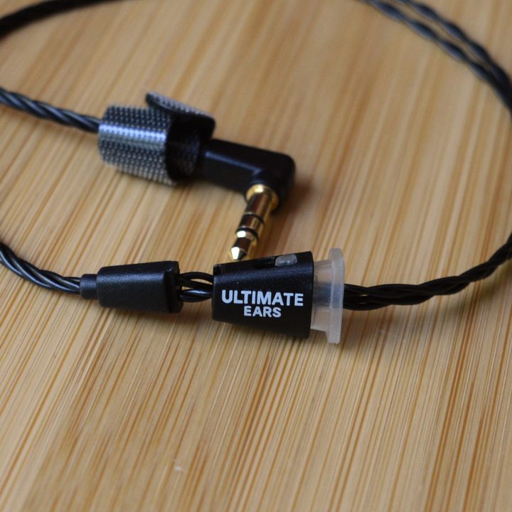 Ultimate Ears Premier wired IEMs, close-up on the audio cable's cinch and 3.5mm plug.