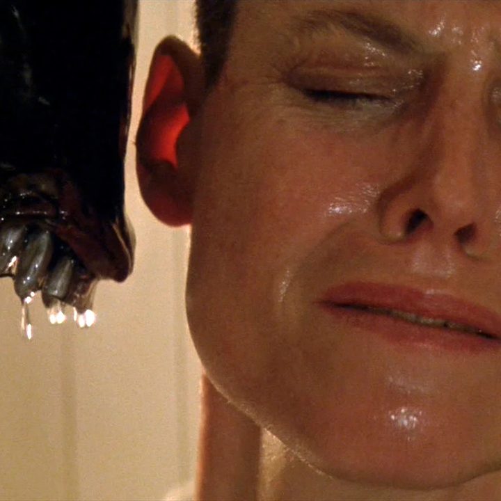 A Xenomorph snarls at Sigourney Weaver in Alien 3.