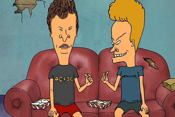Beavis and Butthead sitting on a red couch.