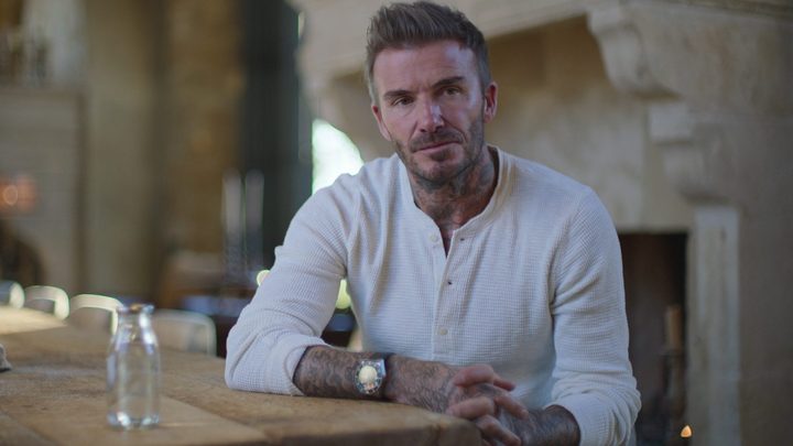 David Beckham sits at a table in Beckham.