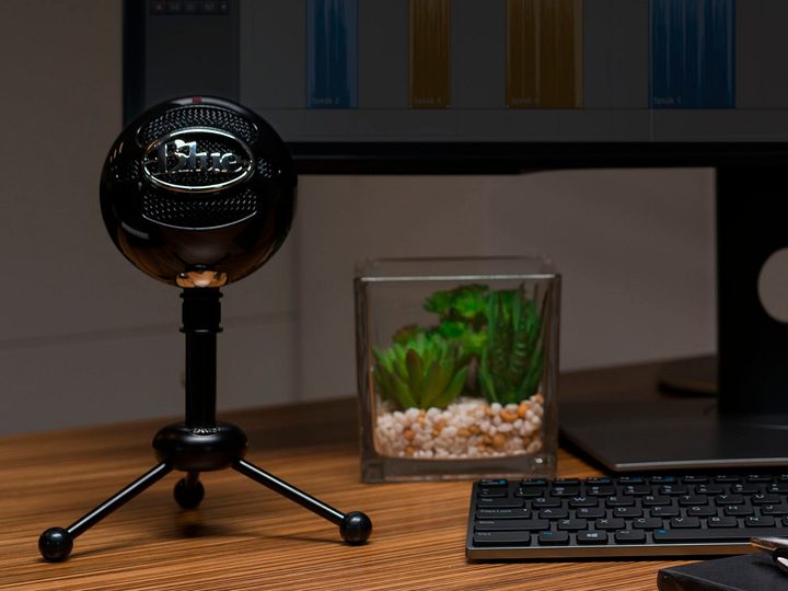 The Blue Snowball microphone on a desk.