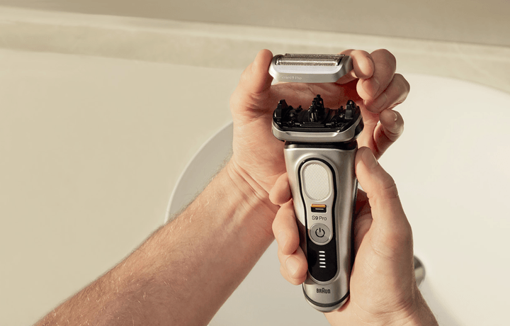 Someone cleaning the Braun Series 9 Shaver.