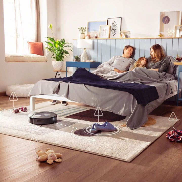The Roomba Combo j7+ vacuuming a bedroom.